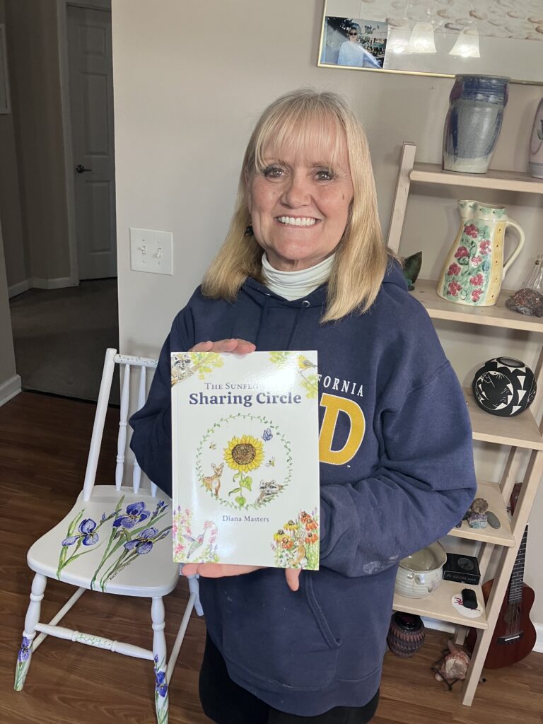 image of the author Diana Masters holding her book The Sunflower's Sharing Circle