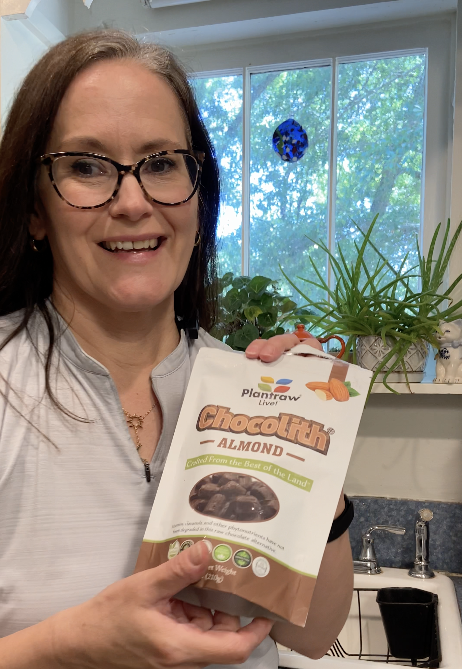 User-generated content example showing small business product in a TikTok video. A woman holding a package of vegan truffles.